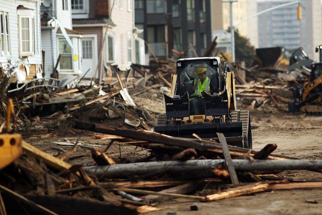 Crews tackle piles of debris on Saturday, November 10, 2012 as clean-up continues where a large section of the iconic boardwalk was washed away.